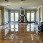 Flood Cleanup In Home. Emergency Water Extraction In Flooded Living Room. Water Damage Restoration.